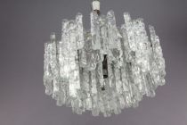 A tiered glass chandelier on a chrome frame by J.T...
